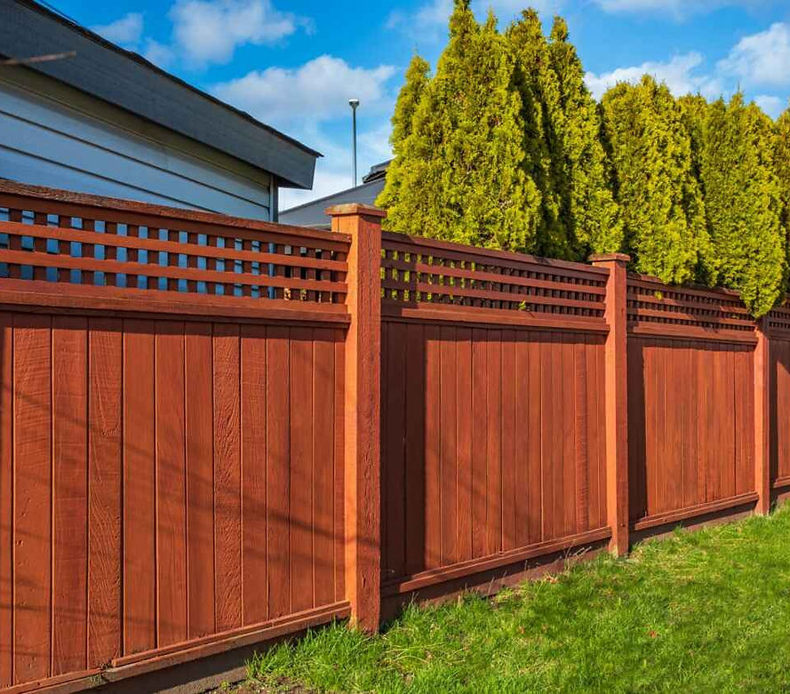 A reddish-brown wood fence in excellent condition for outdoor projects by Fircrest Handyman