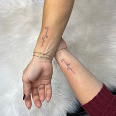 Custom fine line flash tattoo design featuring delicate line work and floral art created at Blush & Blade in Pinellas Park FL.