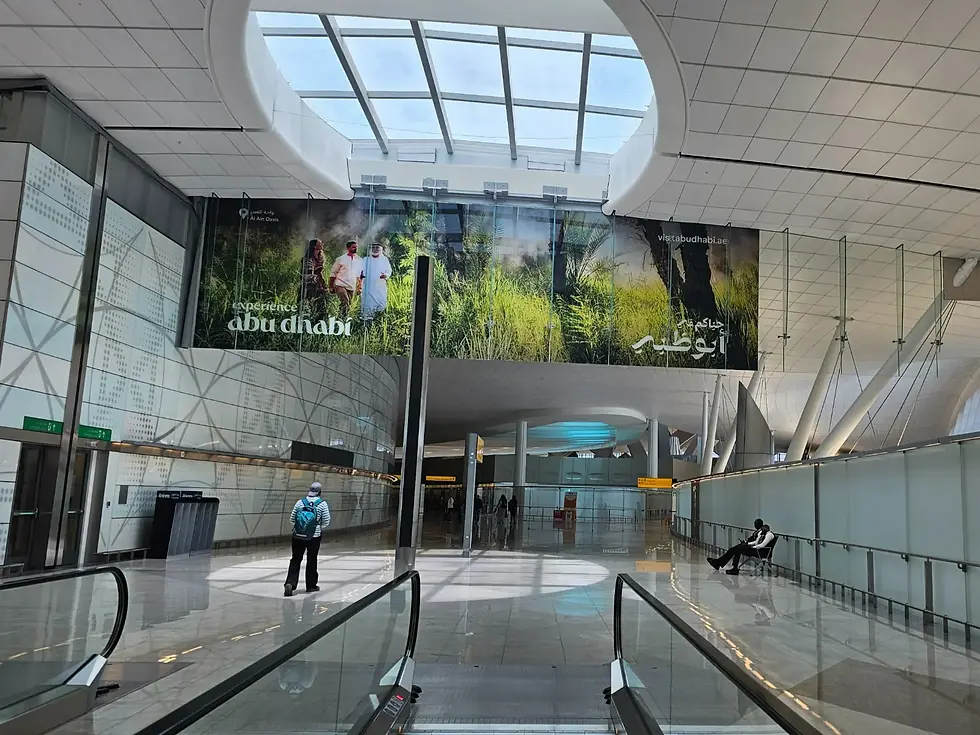 Modern glass architecture inside Zayed International Airport Terminal in Abu Dhabi.