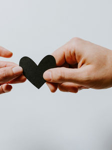 hands holding a heart in support of someone at the mikveh