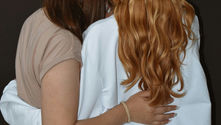two women supporting an embracing eachother