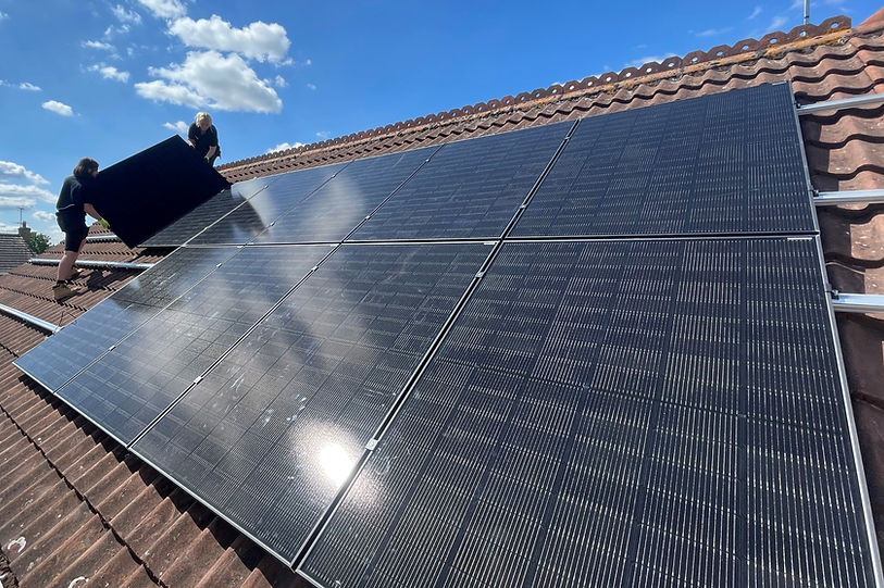 image of two workers installing solar panels on a roof