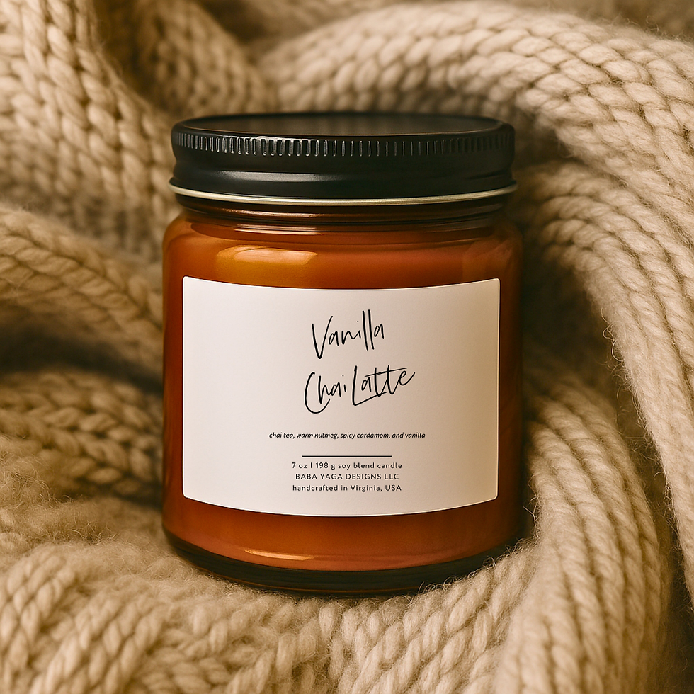 Amber jar candle with black lid and white label, lying on a light brown sweater.