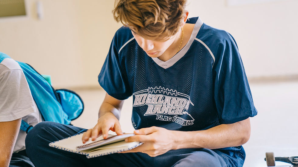 Close-up view of a student athlete writing goals in a journal