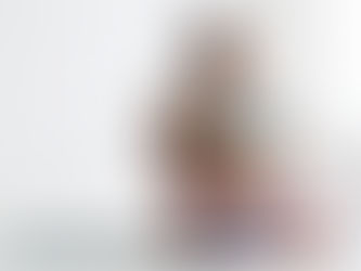 A pregnant woman, smiling holding her large belly