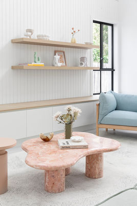 Pastel-toned lounge with pink marble coffee table