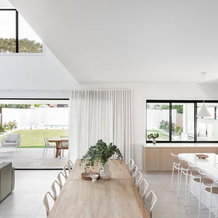 Open-plan kitchen and dining overlooking pool and garden