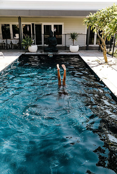 Heated pool at Sundara Beach House with guests enjoying the sun