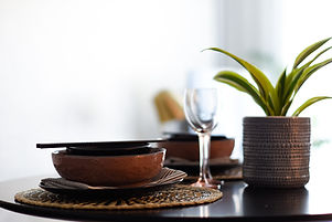 A glass table laid in a contemporary style in a show home in Southend, Essex designed by Amberley Studio.