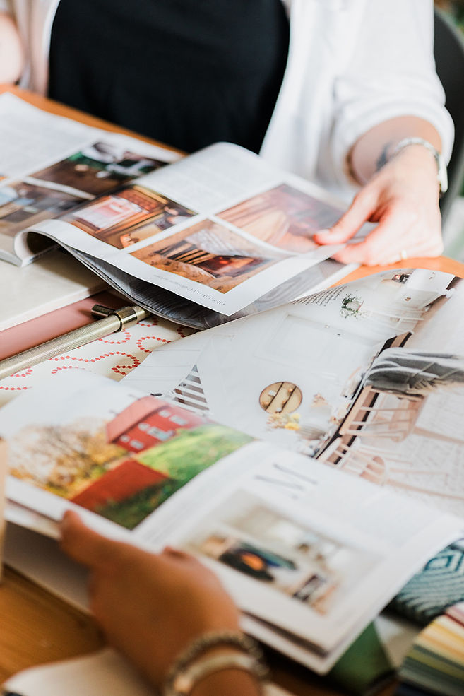 Close up shot of designer looking through magazines.