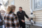 Home inspector explaining inspection details to clients in a comfortable living room setting
