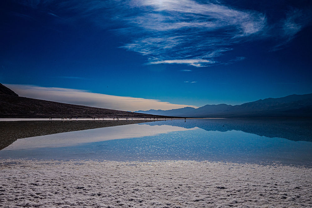 Salt flats reflecting blue sky at Badwater Basin