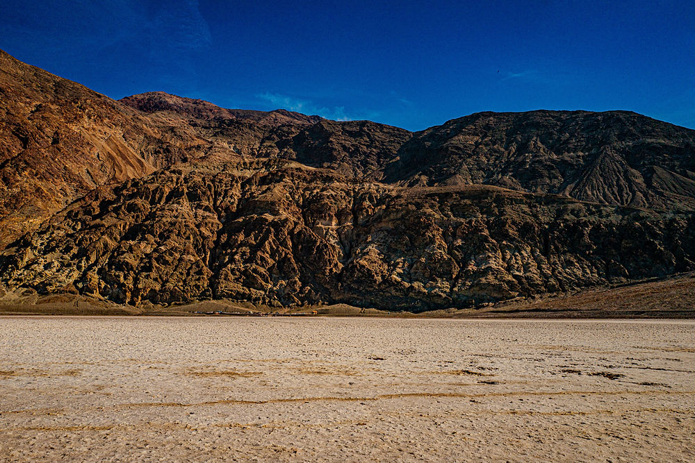 Rugged mountains over desert salt flats in Death Valley.