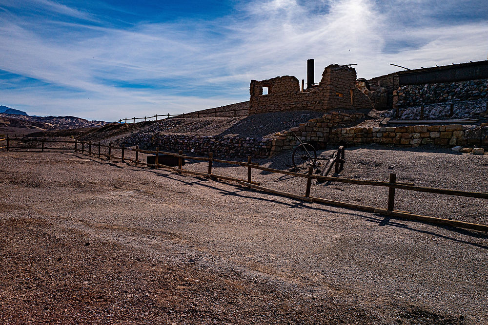 Stone ruins in Death Valley under a bright blue sky.