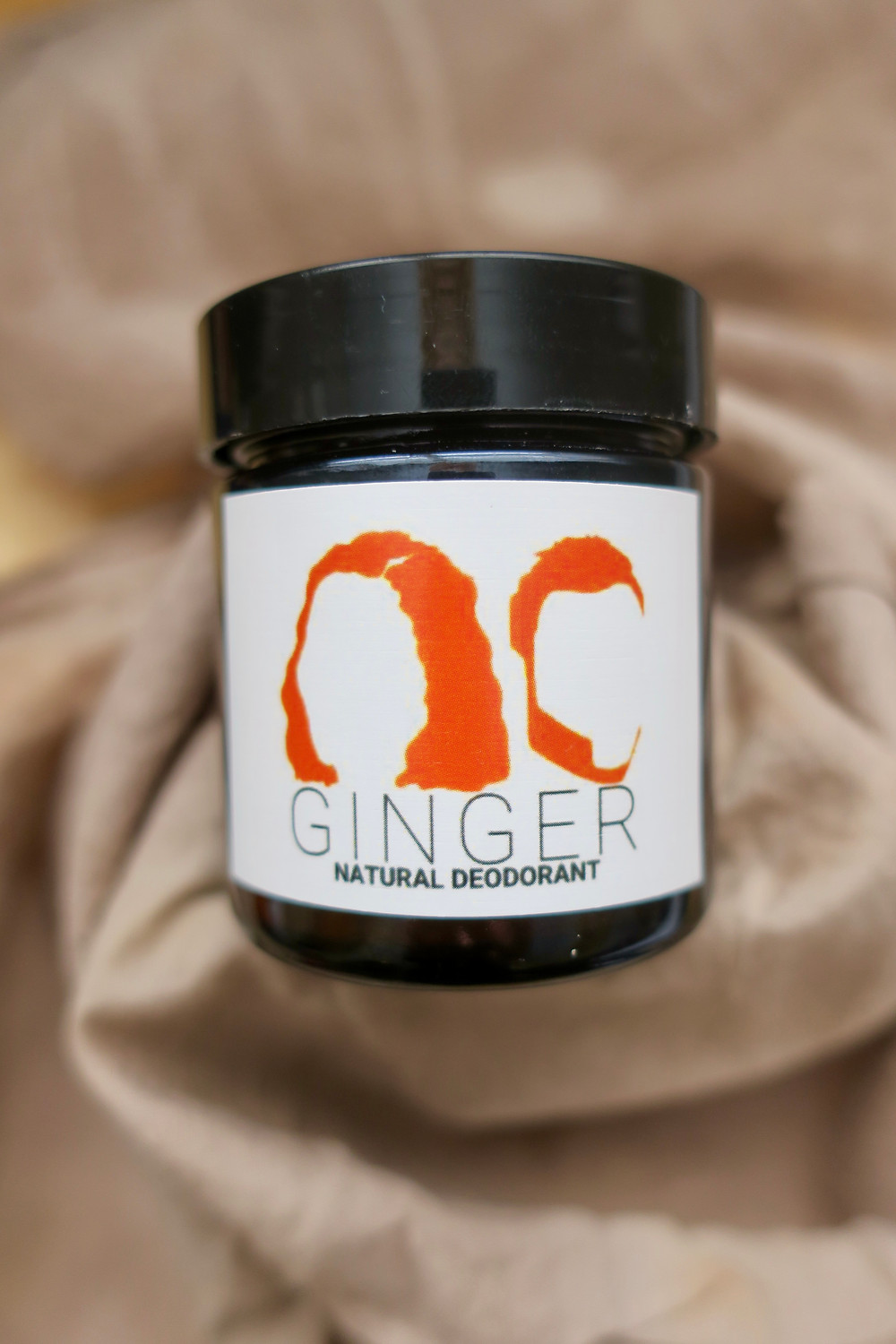 Deodorant jar with "GINGER Natural deodorant" on label