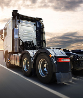 semi-truck-driving-highway-road-sunset-sky-road-freight-truck-logistics-transport-concept.