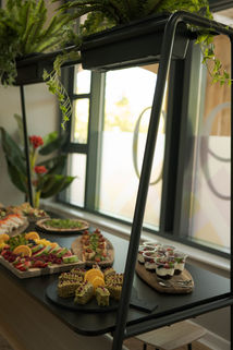 Tiered canapé display stand by window at event — Fourteen Lakes Catering, Milton Keynes