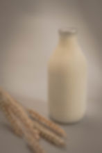 BOTTLE OF MILK ON NEUTRAL BACKGROUND