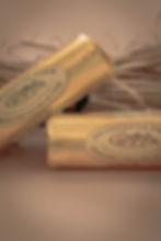 Wrapped farmhouse butter on a rustic surface.