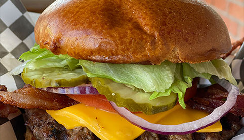 Big Burger on table with cheese and lettuce and tomato 