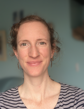 Me, Paula, a white woman with her hair tied back, is smiling into the camera.