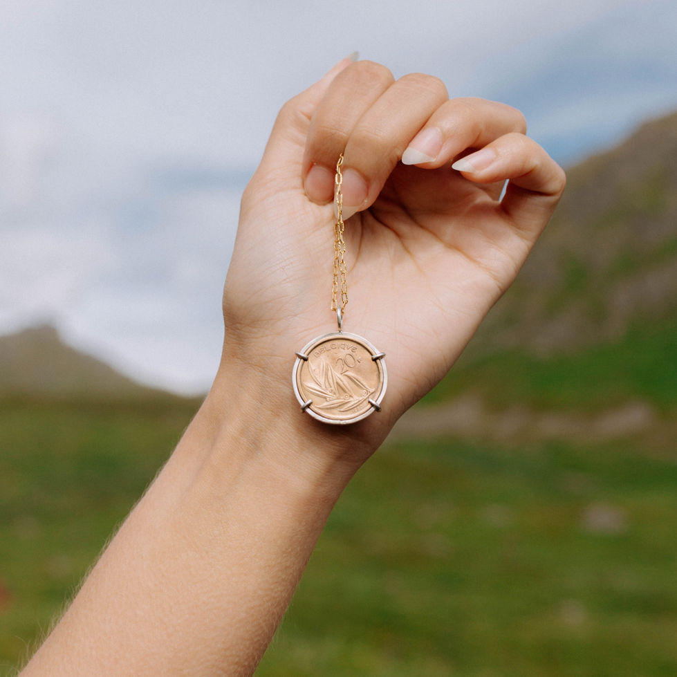 1980 Belgium 20 Francs coin necklace held in hand on gold-filled chain — Menzaman Jewelry