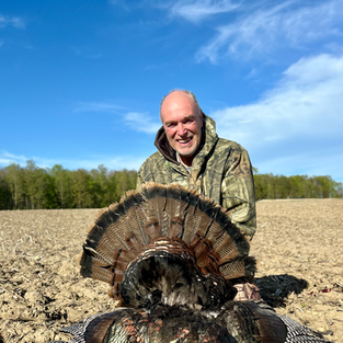 Man with Turkey after a hunt.