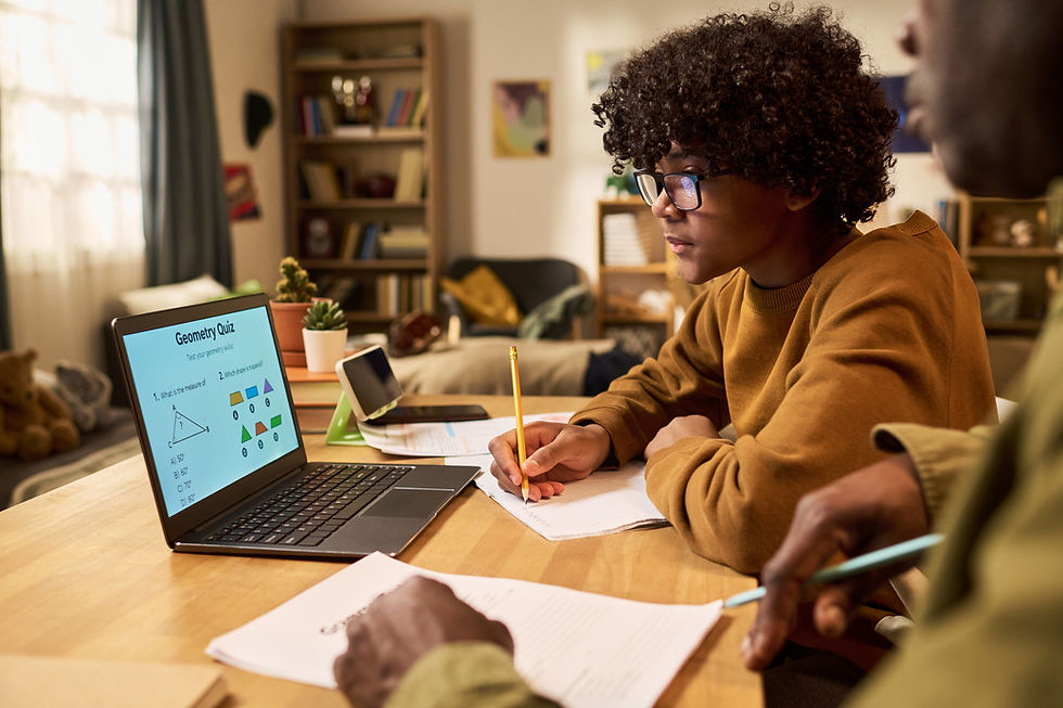 Young boy working one-on-one with a tutor at home on geometry homework, building his best study habits