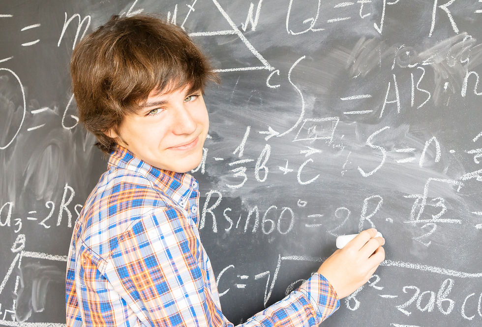 Chattanooga student working on end-of-year math review on chalk board with a tutor