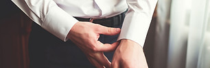 Man Fixing Dress Shirt