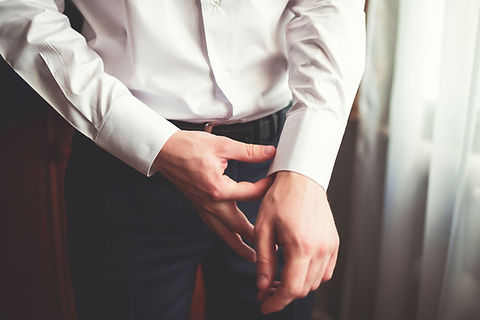 Man Fixing Dress Shirt