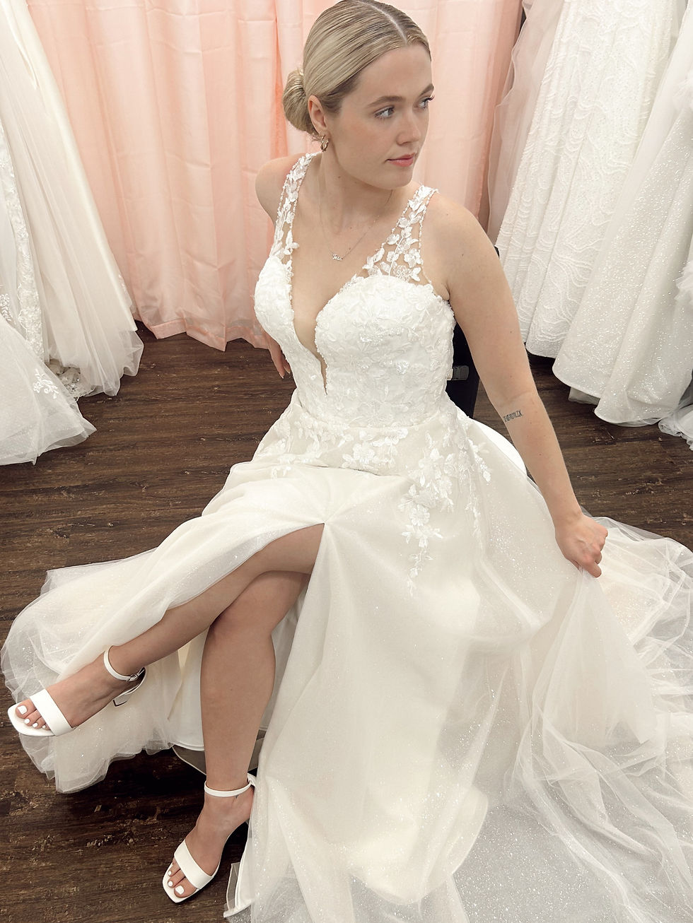 Bride sitting with legs crossed, looking over shoulder
