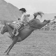 Champion rodeo rider Kenny McLean on a bucking horse