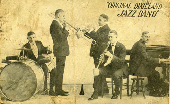 Promotional postcard for the Original Dixieland Jazz Band from 1918 featuring a photo of the band playing their respective instruments.