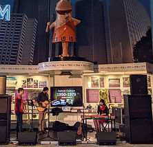 Three piece band, Olivia Dear, performs in Gallery of Culture at the Detroit Historical Museum.