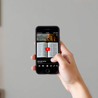 an image of a person holding a cell phone that is on a youtube channel showing a book of t