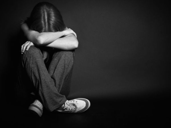 a girl is sitting alone darkness