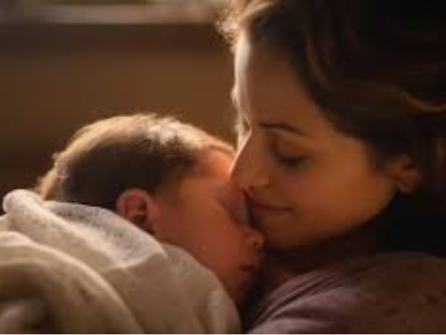A mother hugging the baby to sleep