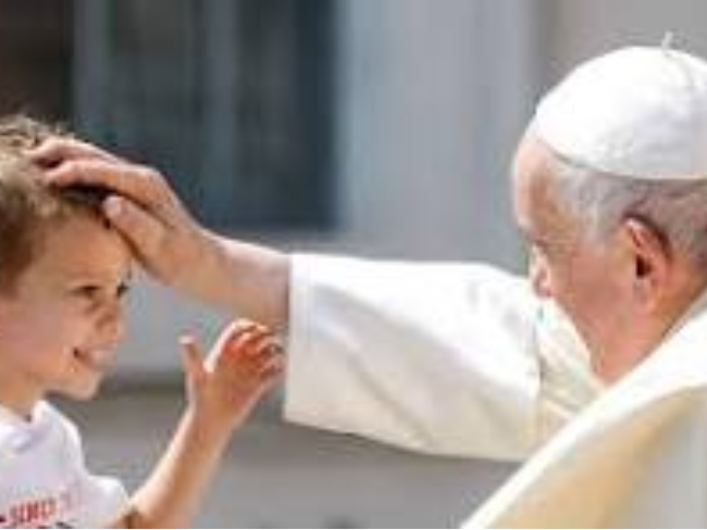 Pope Francis is blessing a child