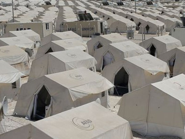 migrants settle in tent
