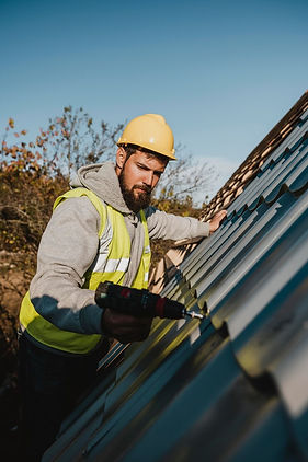 man-working-roof-with-drill_23-2148748774.jpg