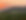 Horses grazing in a field at sunset
