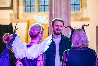 Director Harvey Evans with members of the chorus.jpeg