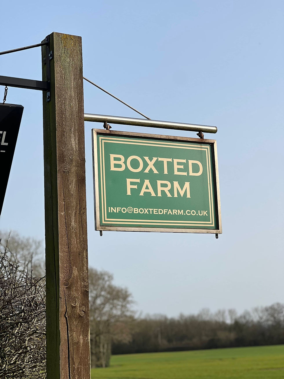 A beautful old sign on a wooden post reading Boxted Farm where In-Excess are based