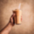 a man hand holding up a smoothie. for a customer testimonial.jpg