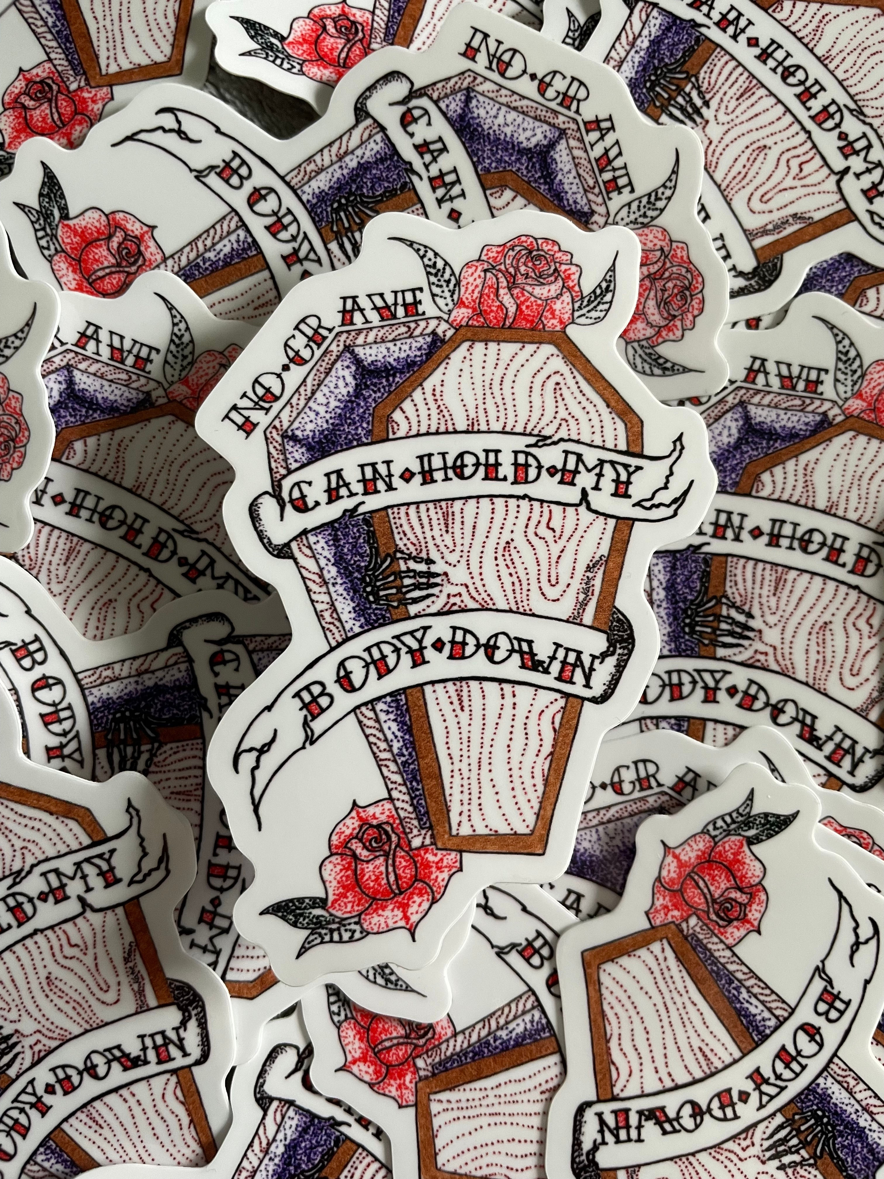 A sticker in a tattoo style of a skeleton hand opening a coffin from the inside with the words "no grave can hold my body down"