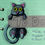 Thumbnail: A two piece sticker of a black cat made to look like its hanging off of something on a green piece of paper wrapped around a purple piece of tape reading "to do"