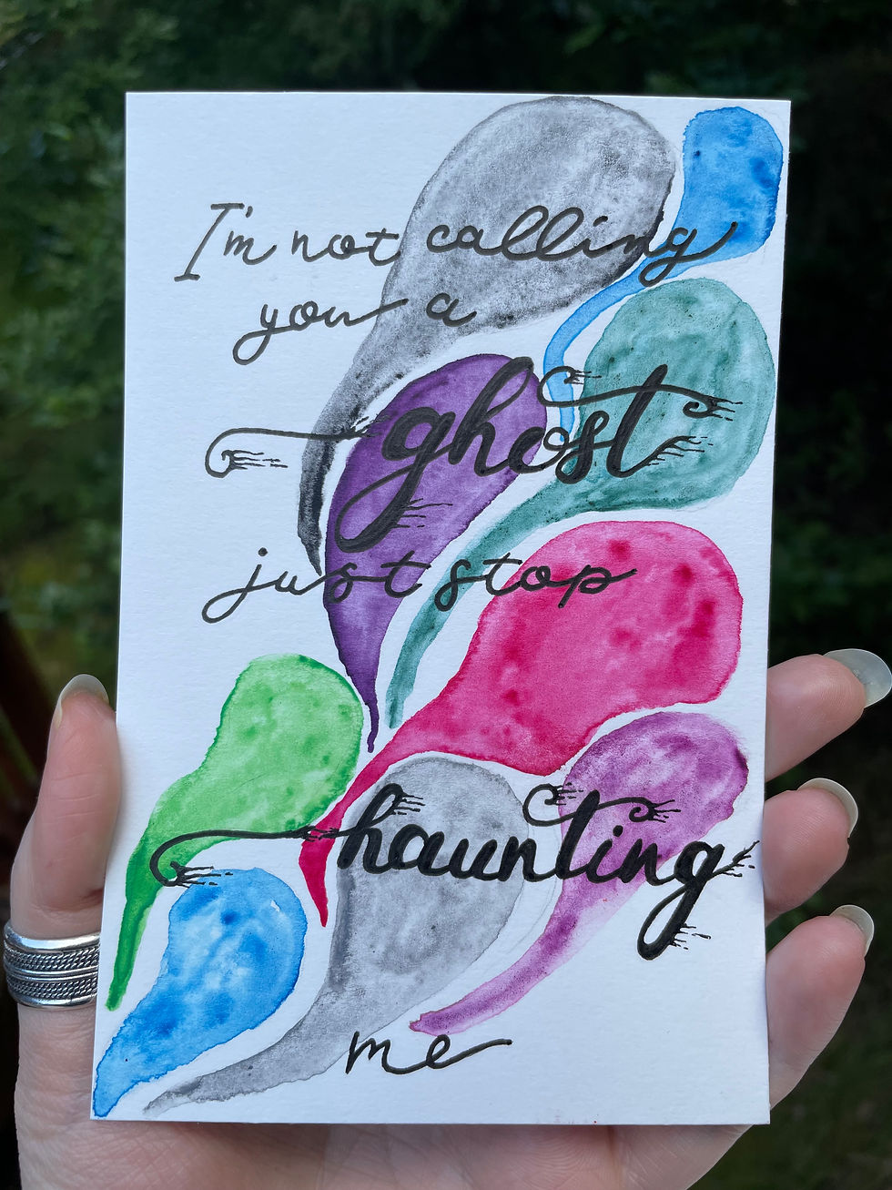 A painting of colorful ghost shapes with the words "I'm not calling you a ghost just stop haunting me"