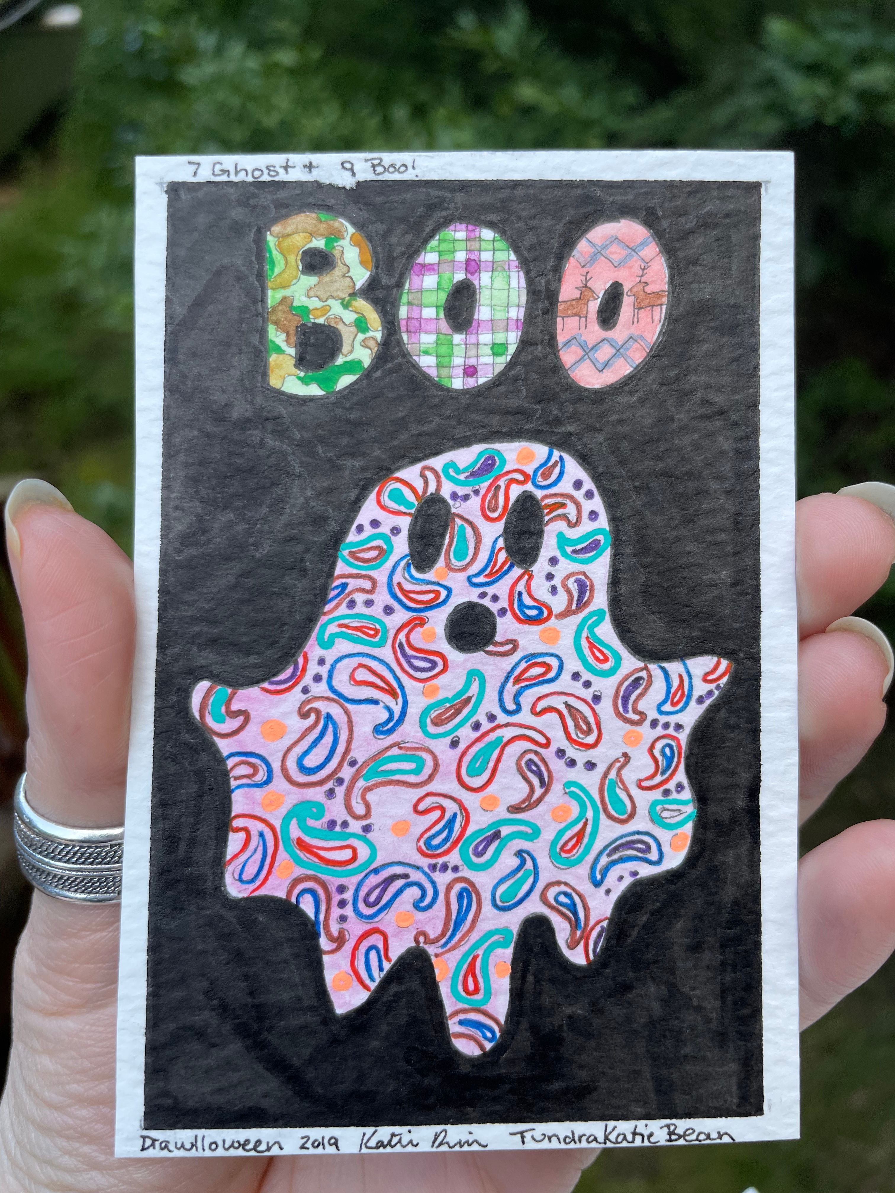 A drawing of a ghost in a paisley pattern saying "boo"