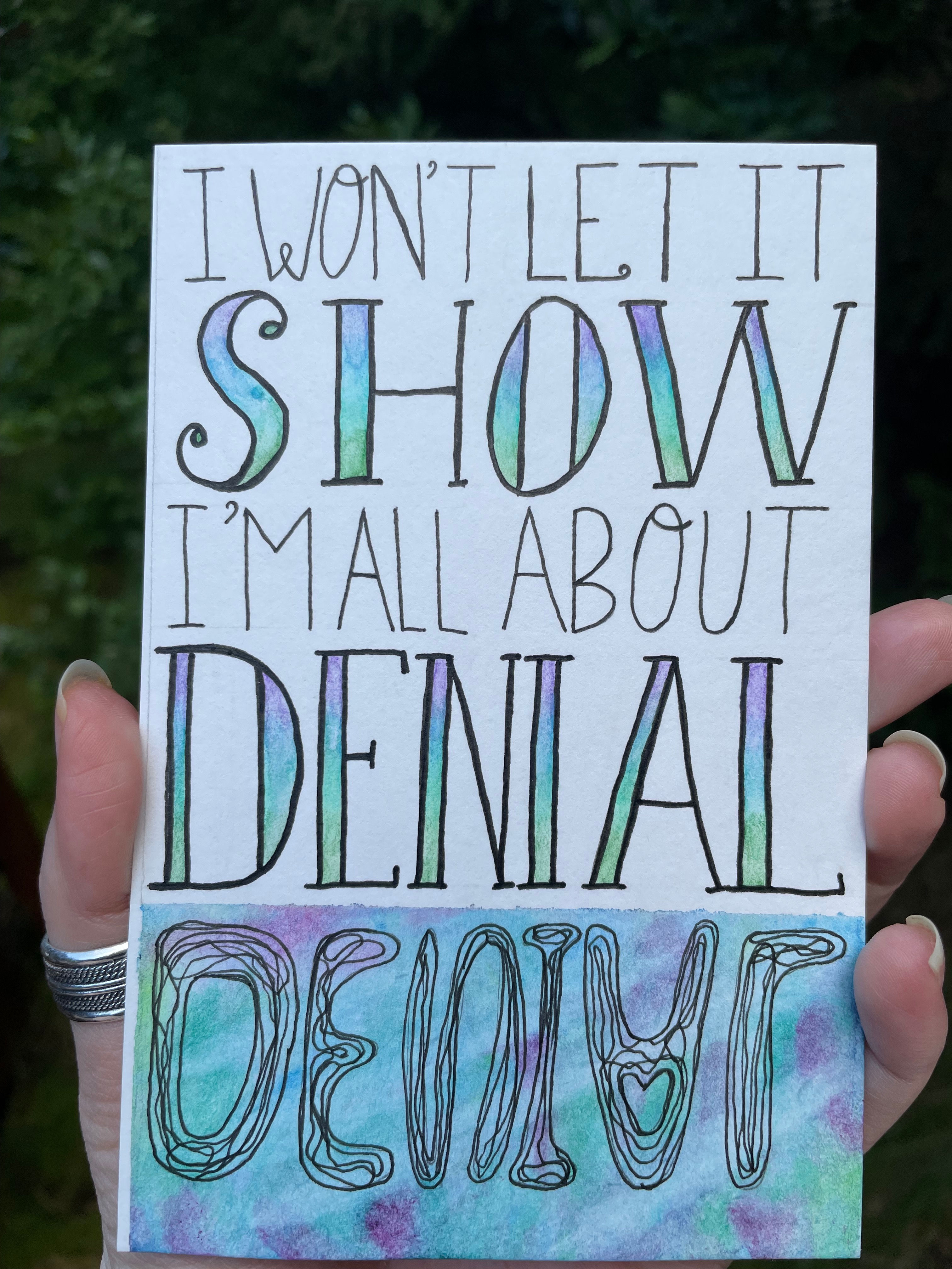 Typography with cool colored details reading "I won't let it show I'm all about denial"